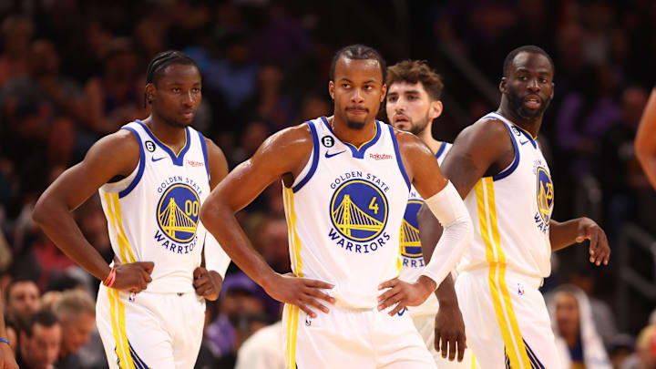 Golden State Warriors guard Moses Moody (4), forward Jonathan Kuminga (00) and forward Draymond Green (23) against the Phoenix Suns at Footprint Center. 