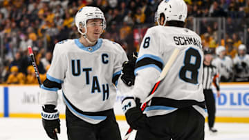 Utah Hockey Club center Nick Schmaltz celebrates a goal with center Clayton Keller against the Nashville Predators.