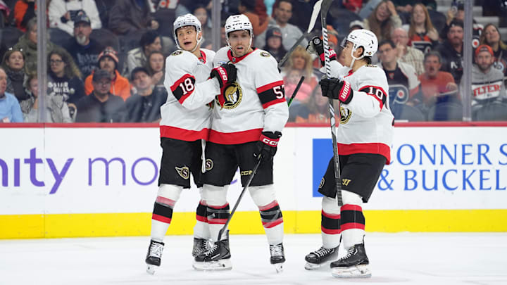 Nov 8, 2025; Philadelphia, Pennsylvania, USA; Ottawa Senators center Tim Stutzle (18) celebrates with left wing David Perron (57) and defenseman Jordan Spence (10) after scoring a goal against the Philadelphia Flyers in the first period at Xfinity Mobile Arena. Mandatory Credit: Kyle Ross-Imagn Images