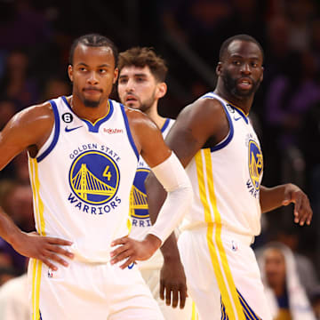 Oct 25, 2022; Phoenix, Arizona, USA; Golden State Warriors guard Moses Moody (4), forward Jonathan Kuminga (00) and forward Draymond Green (23) against the Phoenix Suns at Footprint Center. Mandatory Credit: Mark J. Rebilas-Imagn Images
