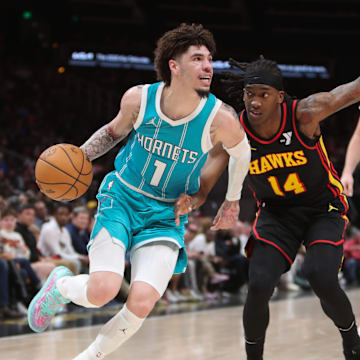 Mar 12, 2025; Atlanta, Georgia, USA; Charlotte Hornets guard LaMelo Ball (1) works past Atlanta Hawks guard Terance Mann (14) during the second half at State Farm Arena. Mandatory Credit: Mady Mertens-Imagn Images