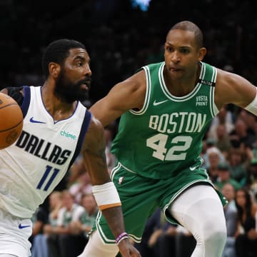 Jun 17, 2024; Boston, Massachusetts, USA; Dallas Mavericks guard Kyrie Irving (11) drives to the basket against Boston Celtics guard Jrue Holiday (left) and center Al Horford (right) during the second quarter in game five of the 2024 NBA Finals at TD Garden. Mandatory Credit: Peter Casey-USA TODAY Sports