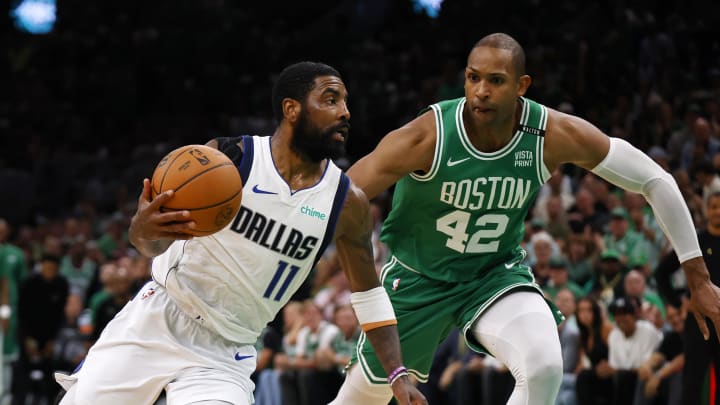 Jun 17, 2024; Boston, Massachusetts, USA; Dallas Mavericks guard Kyrie Irving (11) drives to the basket against Boston Celtics guard Jrue Holiday (left) and center Al Horford (right) during the second quarter in game five of the 2024 NBA Finals at TD Garden. Mandatory Credit: Peter Casey-USA TODAY Sports