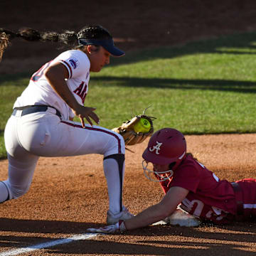 Feb 2, 2024; Tuscaloosa, Alabama, USA; Arizona third baseman Blaise Biringer takes a throw too late to get Alabama base runner Marlie Giles as she goes first to third on a hit as Alabama played Arizona Saturday at Rhoads Stadium.