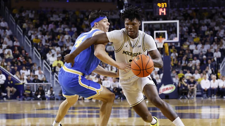 Feb 14, 2026; Ann Arbor, Michigan, USA; Michigan Wolverines guard L.J. Cason (2) dribbles on UCLA Bruins guard Jamar Brown (4) in the first half at Crisler Center. Mandatory Credit: Rick Osentoski-Imagn Images