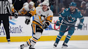 Jan 27, 2025; San Jose, California, USA;  Pittsburgh Penguins center Sidney Crosby (87) watches the puck as San Jose Sharks defenseman Timothy Liljegren (37) lurks in the background during the second period at SAP Center at San Jose. Mandatory Credit: David Gonzales-Imagn Images