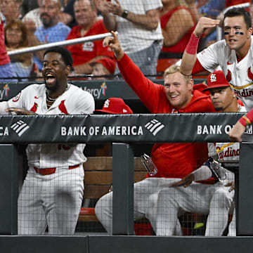 Sep 18, 2024; St. Louis, Missouri, USA;  St. Louis Cardinals right fielder Lars Nootbaar (21)  Luken Baker (26) and right fielder Jordan Walker (18) reacts after first baseman Paul Goldschmidt (not pictured) hit a one run triple against the Pittsburgh Pirates during the third inning at Busch Stadium. Mandatory Credit: Jeff Curry-Imagn Images