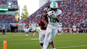 Sep 7, 2024; Blacksburg, Virginia, USA; Marshall Thundering Herd wide receiver Christian Fitzpatrick (16) catches a touchdown pass against Virginia Tech Hokies safety Mose Phillips III (18) during the second quarter at Lane Stadium. Mandatory Credit: Peter Casey-Imagn Images