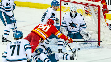 Apr 13, 2025; Calgary, Alberta, CAN; San Jose Sharks goaltender Georgi Romanov (31) makes a save against Calgary Flames left wing Blake Coleman (20) during the second period at Scotiabank Saddledome. Mandatory Credit: Sergei Belski-Imagn Images