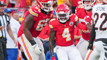 Sep 15, 2024; Kansas City, Missouri, USA; Kansas City Chiefs wide receiver Rashee Rice (4) is helped up by guard Trey Smith (65) against the Cincinnati Bengals after a penalty during the second half at GEHA Field at Arrowhead Stadium. Mandatory Credit: Denny Medley-Imagn Images