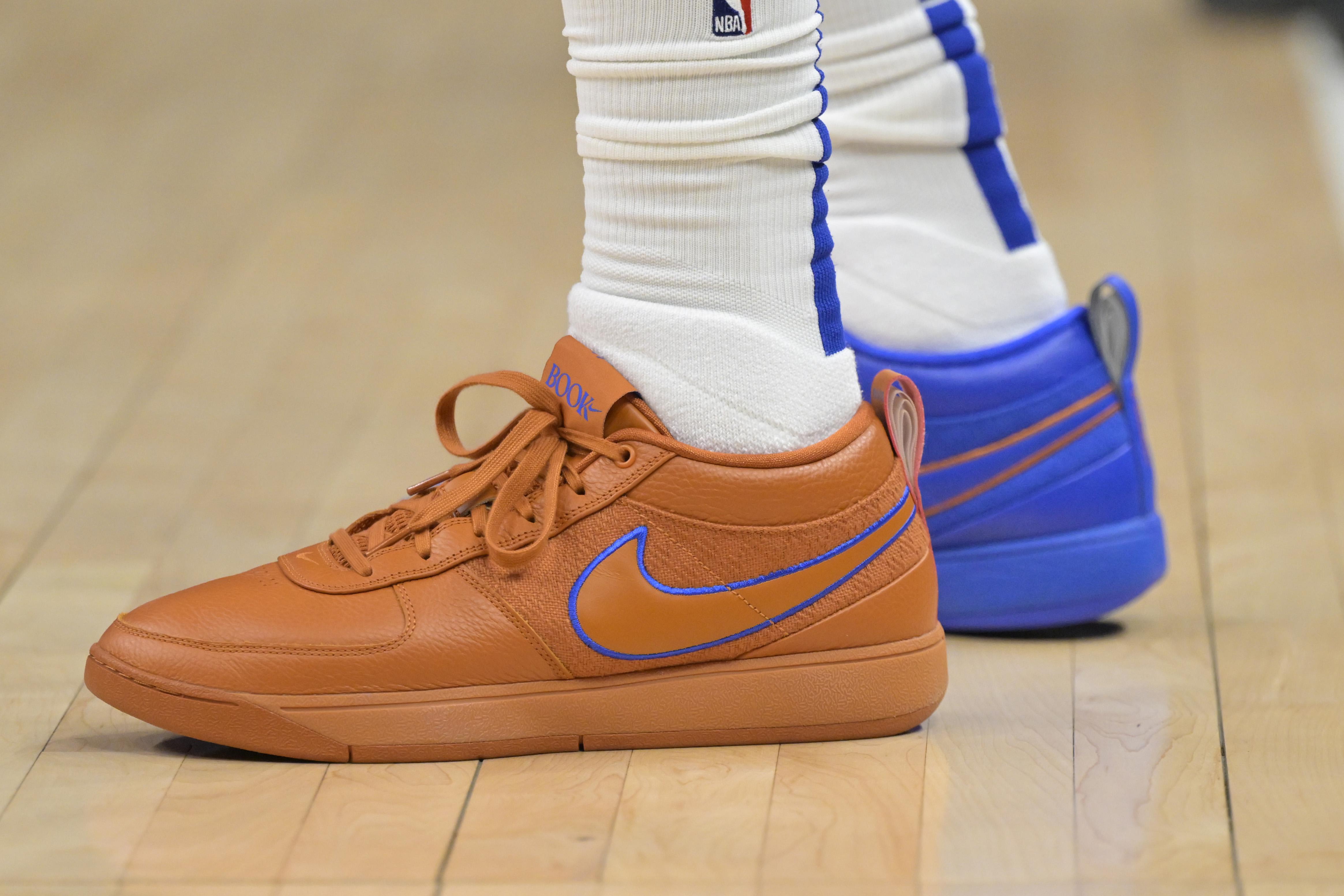 LA Clippers forward P.J. Tucker's orange and blue Nike sneakers.