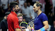 Novak Djokovic and Rafael Nadal shake hands at the net after a match at the Six Kings Slam.