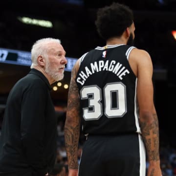 Apr 9, 2024; Memphis, Tennessee, USA; San Antonio Spurs head coach Gregg Popovich (left) talks with forward Julian Champagnie (30) during the first half against the Memphis Grizzlies at FedExForum. Mandatory Credit: Petre Thomas-USA TODAY Sports