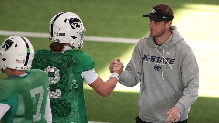 Kansas State head coach Collin Klein slaps hands with senior quarterback Avery Johnson (2) during practice on Tuesday, April 21, 2026.