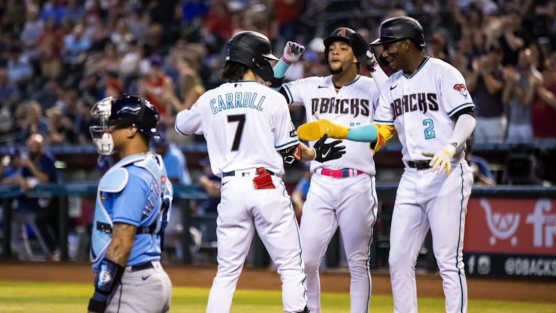 Jun 27, 2023; Phoenix, Arizona, USA; Arizona Diamondbacks outfielder Corbin Carroll (7) celebrates with teammates Geraldo Perdomo (2) and Ketel Marte after hitting a three run home run in the first inning against the Tampa Bay Rays at Chase Field. Mandatory Credit: Mark J. Rebilas-Imagn Images