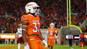 Oct 17, 2024; Blacksburg, Virginia, USA; Virginia Tech Hokies running back Bhayshul Tuten (33) celebrates after scoring a touchdown during the second quarter against the Boston College Eagles at Lane Stadium. Mandatory Credit: Peter Casey-Imagn Images