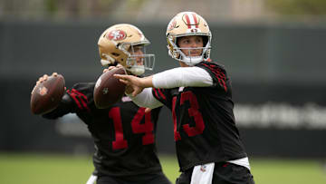 Jul 24, 2025; Santa Clara, CA, USA; San Francisco 49ers quarterbacks Tanner Mordecai (14) and Brock Purdy (13) throw during a passing drill on the second day of training camp. Mandatory Credit: D. Ross Cameron-Imagn Images