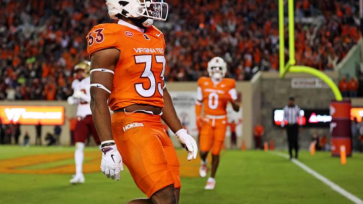 Oct 17, 2024; Blacksburg, Virginia, USA; Virginia Tech Hokies running back Bhayshul Tuten (33) celebrates after scoring a touchdown during the second quarter against the Boston College Eagles at Lane Stadium. Mandatory Credit: Peter Casey-Imagn Images