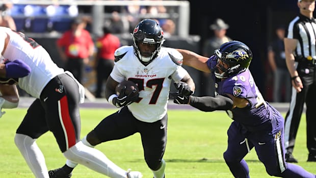 Oct 5, 2025; Baltimore, Maryland, USA; Houston Texans running back Woody Marks (27) runs for a gain past Baltimore Ravens lin