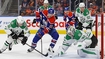 Mar 26, 2025; Edmonton, Alberta, CAN; Dallas Stars goaltender Jake Oettinger (29) makes a save on Edmonton Oilers forward Ryan Nugent-Hopkins (93) during the third period at Rogers Place. Mandatory Credit: Perry Nelson-Imagn Images