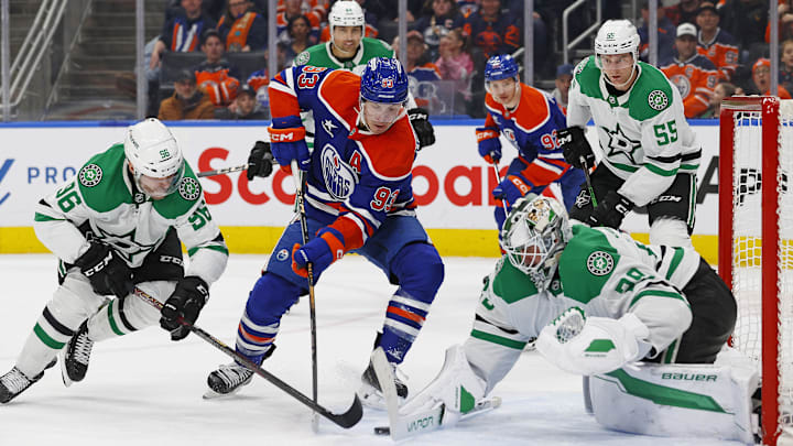Mar 26, 2025; Edmonton, Alberta, CAN; Dallas Stars goaltender Jake Oettinger (29) makes a save on Edmonton Oilers forward Ryan Nugent-Hopkins (93) during the third period at Rogers Place. Mandatory Credit: Perry Nelson-Imagn Images