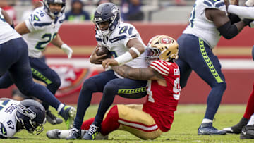 November 17, 2024; Santa Clara, California, USA; San Francisco 49ers defensive end Yetur Gross-Matos (94) sacks Seattle Seahawks quarterback Geno Smith (7) during the second quarter at Levi's Stadium. 