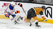May 8, 2025; Las Vegas, Nevada, USA; Edmonton Oilers left wing Viktor Arvidsson (33) trips Vegas Golden Knights defenseman Brayden McNabb (3) during an overtime period of game two of the second round of the 2025 Stanley Cup Playoffs at T-Mobile Arena. Mandatory Credit: Stephen R. Sylvanie-Imagn Images