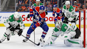 Mar 26, 2025; Edmonton, Alberta, CAN; Dallas Stars goaltender Jake Oettinger (29) makes a save on Edmonton Oilers forward Ryan Nugent-Hopkins (93) during the third period at Rogers Place. Mandatory Credit: Perry Nelson-Imagn Images