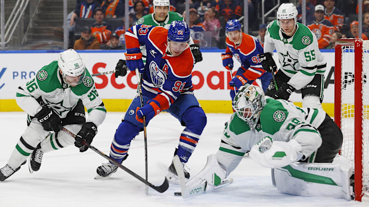 Mar 26, 2025; Edmonton, Alberta, CAN; Dallas Stars goaltender Jake Oettinger (29) makes a save on Edmonton Oilers forward Ryan Nugent-Hopkins (93) during the third period at Rogers Place. Mandatory Credit: Perry Nelson-Imagn Images