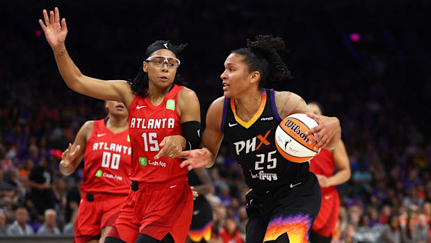 Alyssa Thomas dribbles the ball