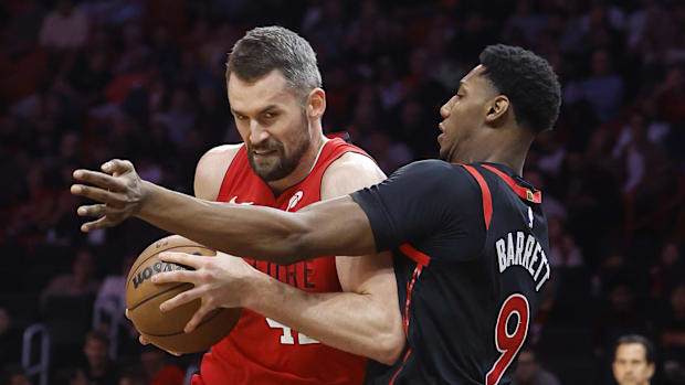 December 12, 2024; Miami, Florida, United States; Toronto Raptors Guard RJ Barrett (9) defends Miami Heat Kevin Love (42) striker during Th