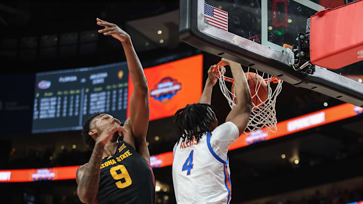 Dec 14, 2024; Atlanta, Georgia, USA; Florida Gators forward Sam Alexis (4) dunks the ball against Arizona State Sun Devils center Shawn Phillips Jr. (9) during the first half at State Farm Arena. Mandatory Credit: Jordan Godfree-Imagn Images