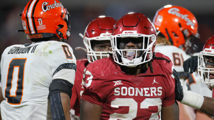 Oklahoma's DaShaun White (23) celebrates beside Oklahoma State's Ollie Gordon (0) after a sack during a Bedlam college football game between the University of Oklahoma Sooners (OU) and the Oklahoma State University Cowboys (OSU) at Gaylord Family-Oklahoma Memorial Stadium in Norman, Okla., Saturday, Nov. 19, 2022. Oklahoma won 28-13.

cutout 23