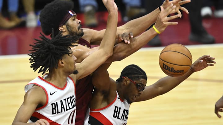 Nov 30, 2023; Cleveland, Ohio, USA; Cleveland Cavaliers center Jarrett Allen (31) reaches for a rebound beside Portland Trail Blazers guard Shaedon Sharpe (17) and guard Scoot Henderson (00) in the fourth quarter at Rocket Mortgage FieldHouse. Mandatory Credit: David Richard-Imagn Images