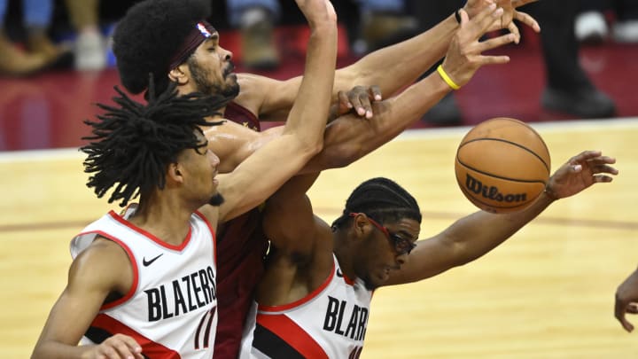 Nov 30, 2023; Cleveland, Ohio, USA; Cleveland Cavaliers center Jarrett Allen (31) reaches for a rebound beside Portland Trail Blazers guard Shaedon Sharpe (17) and guard Scoot Henderson (00) in the fourth quarter at Rocket Mortgage FieldHouse. Mandatory Credit: David Richard-USA TODAY Sports