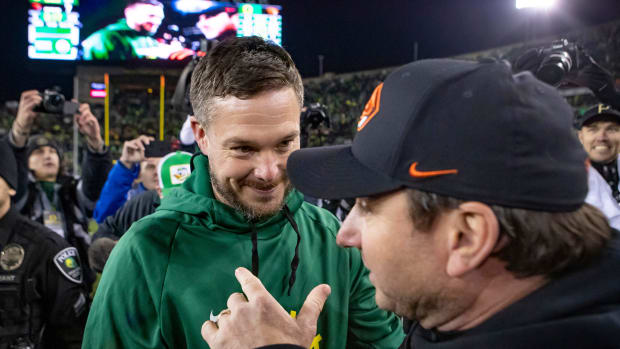 Oregon head coach Dan Lanning talks with Oregon State head coach Jonathan Smith as the No. 6 Oregon Ducks take on the No. 16 