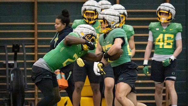 Oregon inside linebacker Jeffrey Bassa, left, strips the ball from Oregon inside linebacker Brayden Platt as the Oregon Ducks