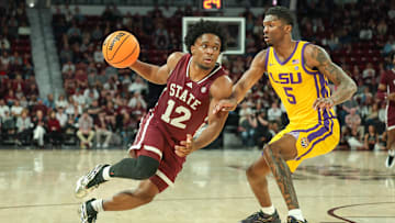 Mar 1, 2025; Starkville, Mississippi, USA; Mississippi State Bulldogs guard Josh Hubbard (12) drives to the basket against LSU Tigers guard Cam Carter (5) during the second half at Humphrey Coliseum. Mandatory Credit: Wesley Hale-Imagn Images