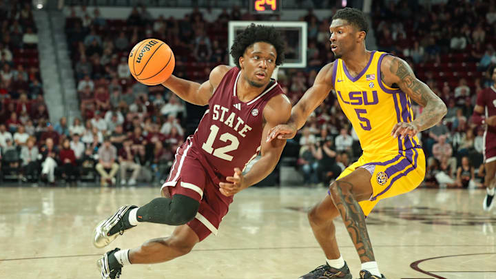 Mar 1, 2025; Starkville, Mississippi, USA; Mississippi State Bulldogs guard Josh Hubbard (12) drives to the basket against LSU Tigers guard Cam Carter (5) during the second half at Humphrey Coliseum. Mandatory Credit: Wesley Hale-Imagn Images