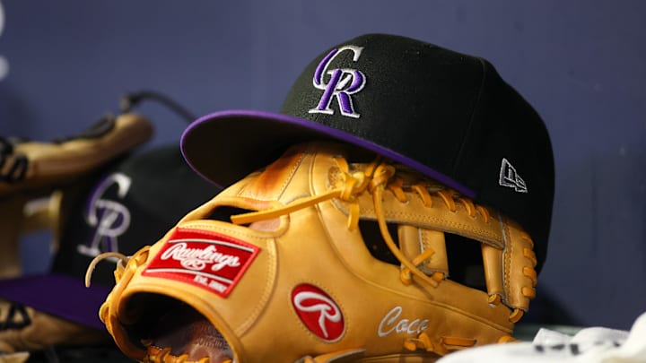 Jun 15, 2023; Atlanta, Georgia, USA; A detailed view of a Colorado Rockies hat and glove on the bench against the Atlanta Braves in the ninth inning at Truist Park. Jun 15, 2023; Atlanta, Georgia, USA; A detailed view of a Colorado Rockies hat and glove on the bench against the Atlanta Braves in the ninth inning at Truist Park.