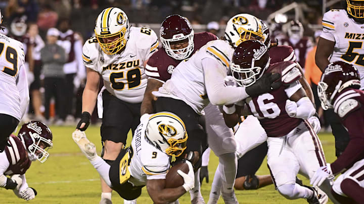 Nov 23, 2024; Starkville, Mississippi, USA;  Missouri Tigers running back Marcus Carroll (9) dives for extra yardage against the Mississippi State Bulldogs during the fourth quarter at Davis Wade Stadium at Scott Field. Mandatory Credit: Matt Bush-Imagn Images