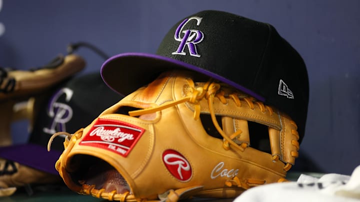 Jun 15, 2023; Atlanta, Georgia, USA; A detailed view of a Colorado Rockies hat and glove on the bench against the Atlanta Braves in the ninth inning at Truist Park. Jun 15, 2023; Atlanta, Georgia, USA; A detailed view of a Colorado Rockies hat and glove on the bench against the Atlanta Braves in the ninth inning at Truist Park.