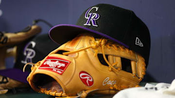 Jun 15, 2023; Atlanta, Georgia, USA; A detailed view of a Colorado Rockies hat and glove on the bench against the Atlanta Braves in the ninth inning at Truist Park.