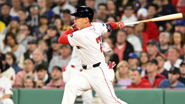 Apr 28, 2024; Boston, Massachusetts, USA;  Boston Red Sox left fielder Masataka Yoshida (7) hits a RBI single against the Chicago Cubs during the third inning at Fenway Park. Mandatory Credit: Brian Fluharty-USA TODAY Sports