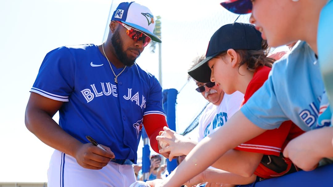 Vladimir Guerrero Jr. signs a baseball for a fan before a Spring Training game last month between the Toronto Blue Jays and Detroit Tigers.