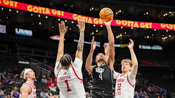 Mar 11, 2025; Kansas City, MO, USA; UCF Knights guard Keyshawn Hall (4) shoots the ball over Utah Utes guard Miro Little (1) during the second half at T-Mobile Center. Mandatory Credit: William Purnell-Imagn Images