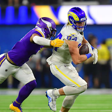 Oct 24, 2024; Inglewood, California, USA; Los Angeles Rams tight end Hunter Long (84) runs the ball  ahead of Minnesota Vikings linebacker Ivan Pace Jr. (0) during the second half at SoFi Stadium. Mandatory Credit: Gary A. Vasquez-Imagn Images
