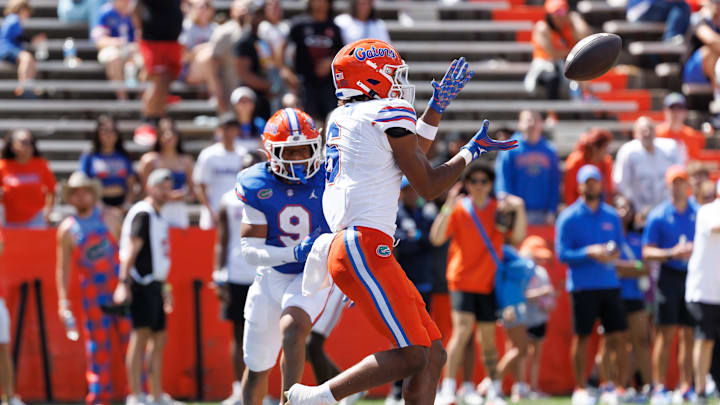 Apr 12, 2025; Gainesville, FL, USA; Florida Gators wide receiver Dallas Wilson (6) catches a pass for a touchdown over Florida Gators defensive back Drake Stubbs (9) during the second half at Ben Hill Griffin Stadium. Mandatory Credit: Matt Pendleton-Imagn Images