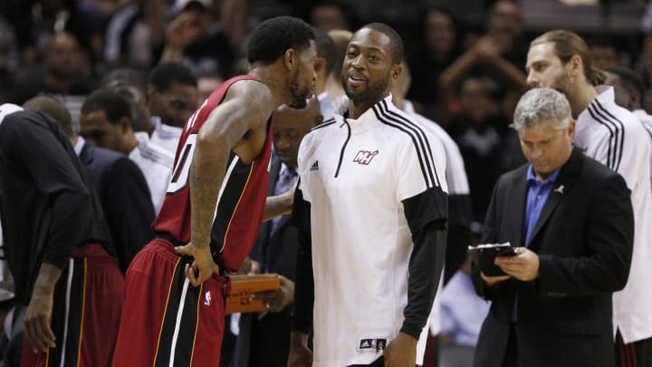 Oct 18, 2014; San Antonio, TX, USA; Miami Heat power forward Udonis Haslem (left) shares a laugh with shooting guard Dwyane Wade (right) during the second half at AT&T Center. The Heat won 111-108 in overtime. Mandatory Credit: Soobum Im-USA TODAY Sports