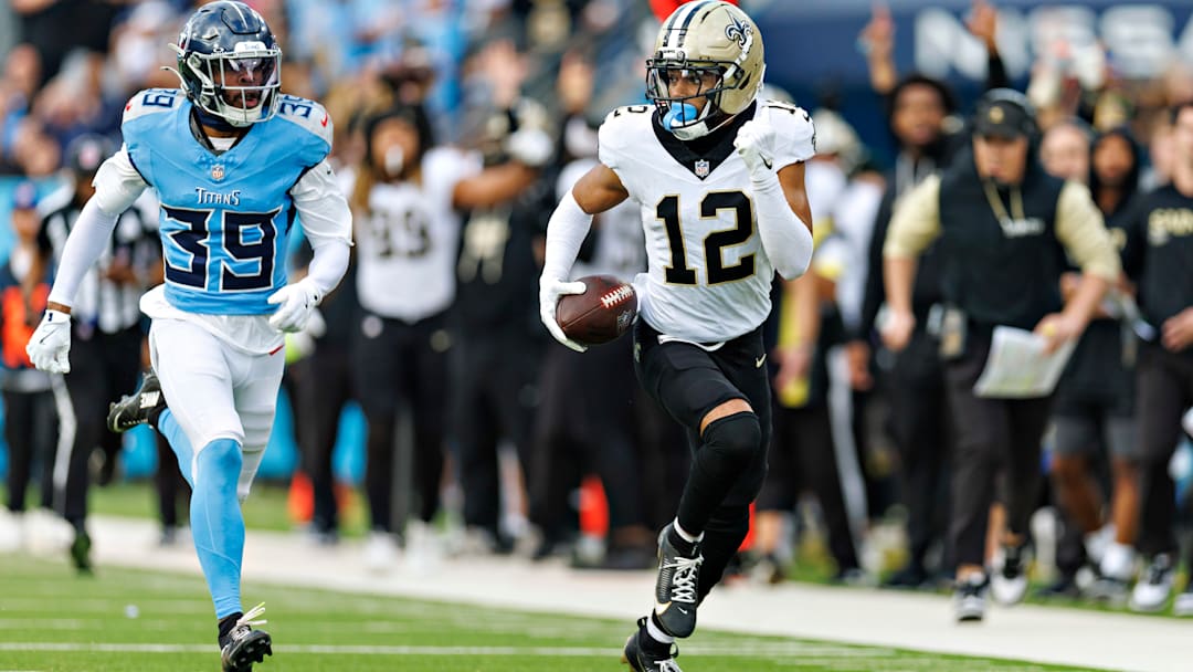 New Orleans Saints WR Chris Olave (12) runs with the ball, away from Tennessee Titans' CB Darrell Baker Jr. (39) on Dec. 28, 2025